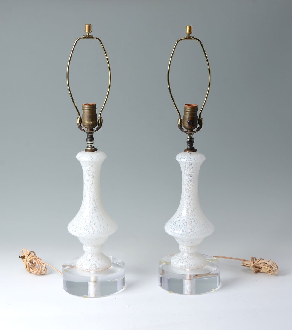 PAIR OF MURANO GLASS LAMPS: PAIR OF MURANO GLASS LAMPS: Clear glass lamps with white oil spot design, affixed to clear lucite bases, single socket fixture, no shades, overall with harps 25" h. x 6 1/4".