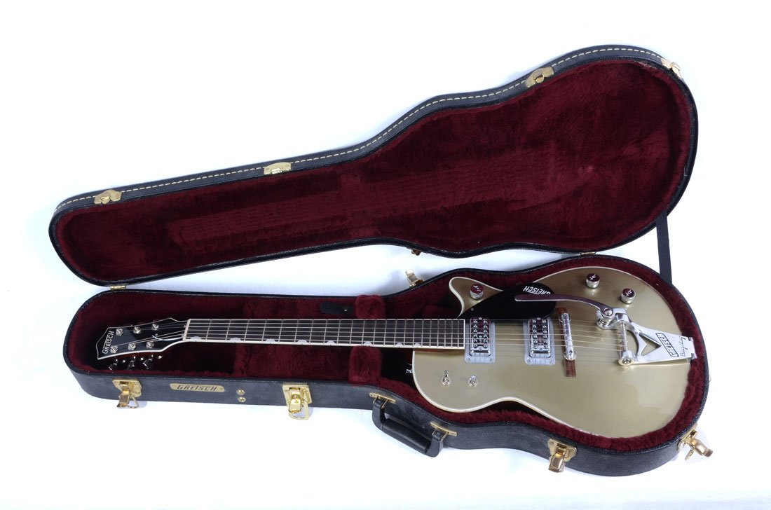 METALLIC GOLD GRETSCH GUITAR AND CASE: METALLIC GOLD GRETSCH GUITAR AND CASE: This guitar has six channels and a built in wammy bar, sold with a locking hard travel case with key. The case contains two spare back plates, strap locks, a wre