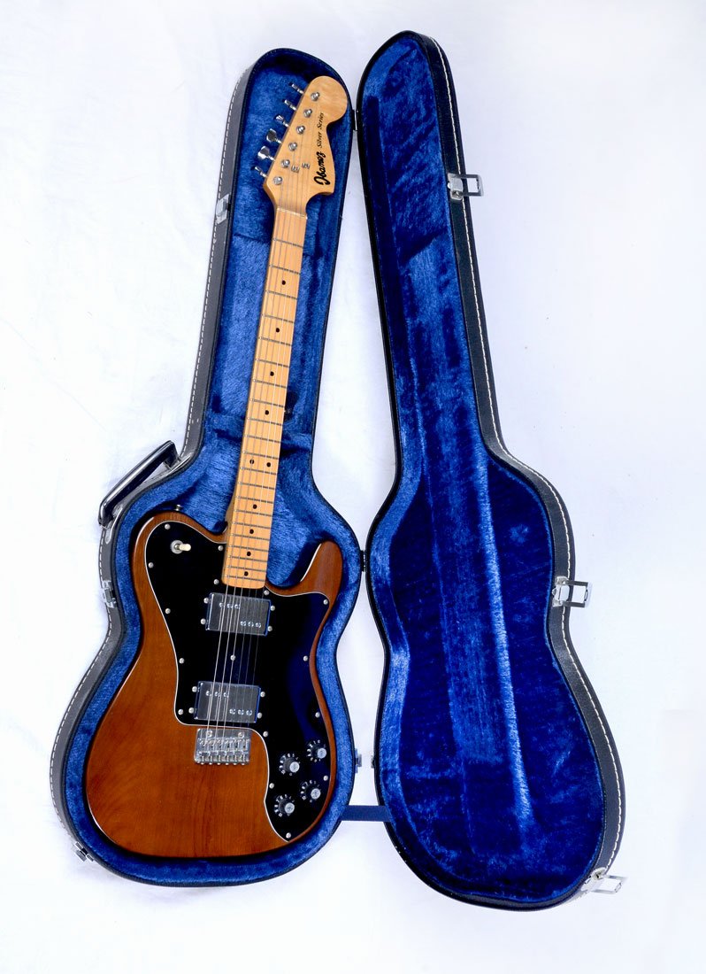 IBANEZ SILVER SERIES GUITAR AND HARD CASE: IBANEZ SILVER SERIES GUITAR AND HARD CASE: Natural wood colored Ibanez "Silver Series" guitar with key and hard travel case. The case includes: guitar picks, two sets of strings, spare neck plate, spa