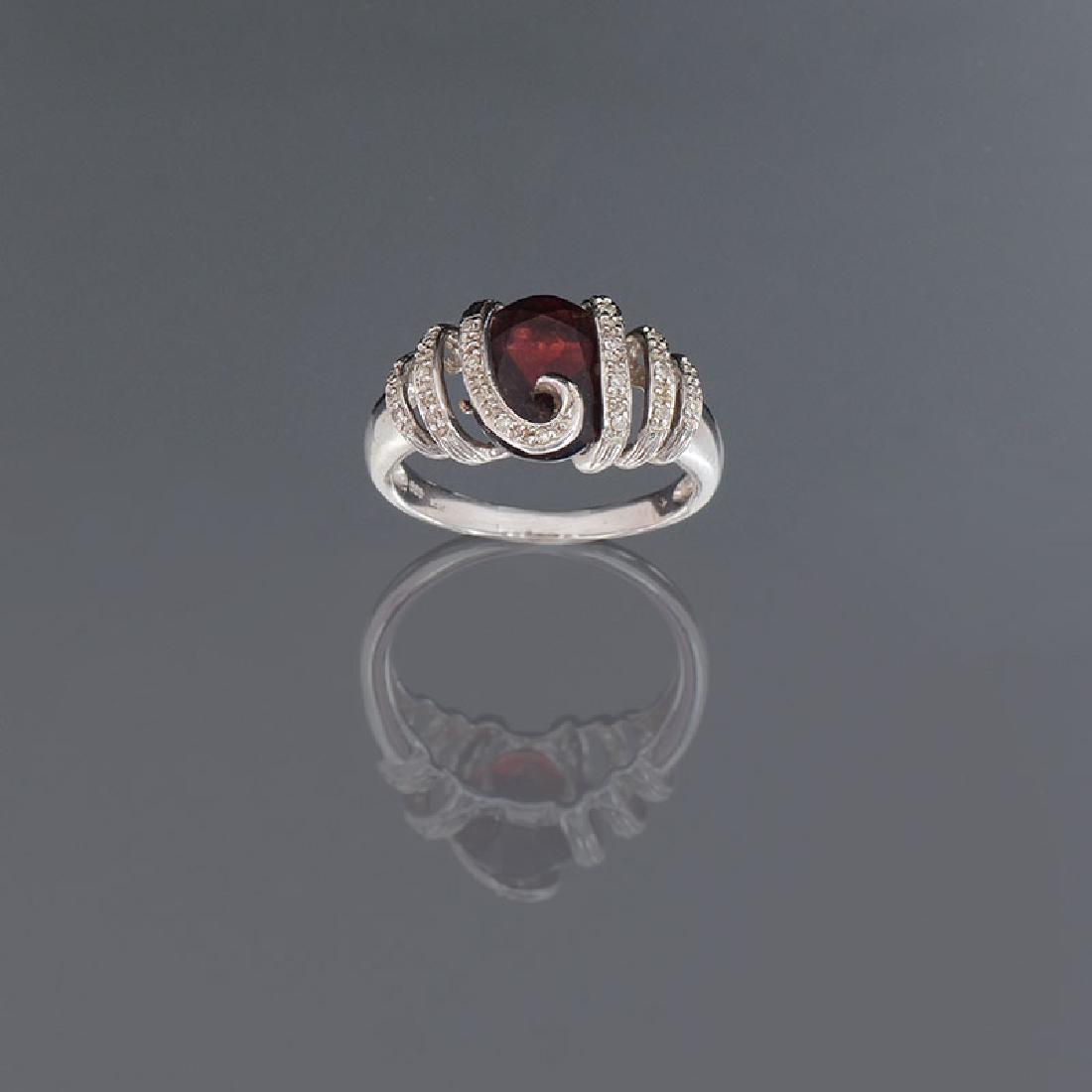 14K GARNET & DIAMOND RING: 14K GARNET & DIAMOND RING: 14K white gold ring contains one oval faceted rhodolite garnet. Weight: 3.50 Ct. Approx. 19 round single cut diamonds. WEIGHT: .25 Ct. Approx. Rated SI in clarity and H-I in