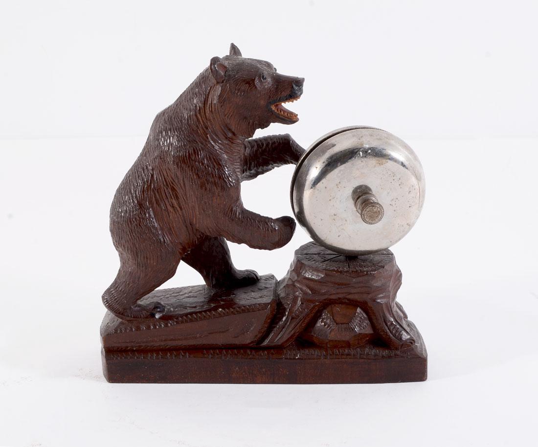 BLACK FOREST CARVED FIGURAL BEAR SERVICE BELL: BLACK FOREST CARVED FIGURAL BEAR SERVICE BELL: Early 20th century, figure of a carved bear standing on back legs with service bell on tree trunk. Unmarked, 7'' h. x 6 13/4'' x 2''.