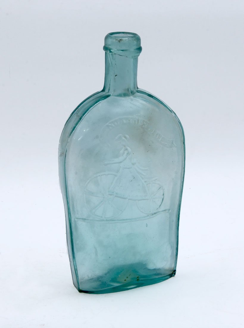 RARE GXIII-1 GIRL ON BICYCLE HISTORICAL FLASK: RARE GXIII-1 GIRL ON BICYCLE HISTORICAL FLASK: Obverse with girl riding an old-fashioned bicycle, head with puffs of hair either side, below a banner with ''NOT FOR JOE'', reverse plain, aquamarine, p