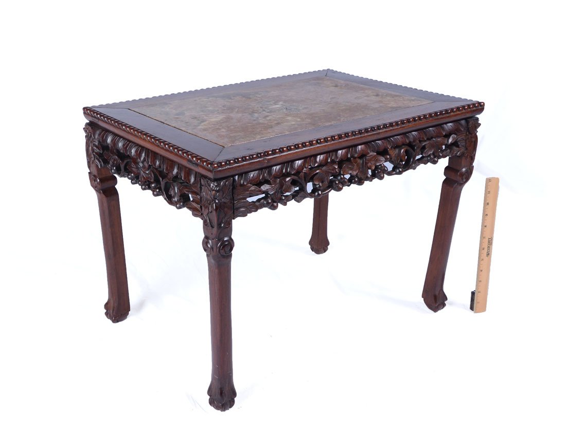 CARVED ORIENTAL MARBLE TOP COFFEE TABLE: CARVED ORIENTAL MARBLE TOP COFFEE TABLE: Inset variegated marble top, pierced carved skirt with foliate motifs, carved legs ending in stylized feet, 18 3/4" h. x 25" x 18 1/2".