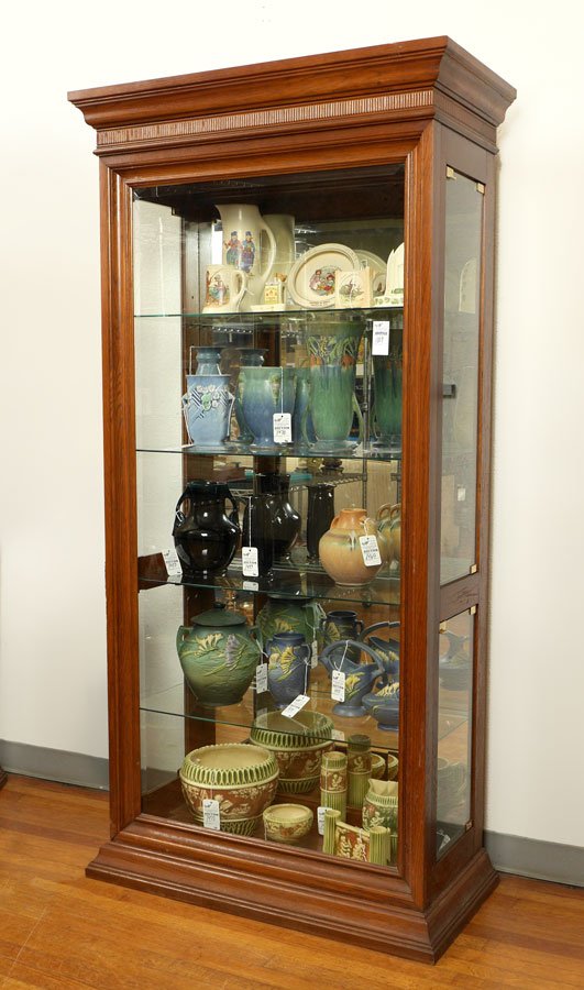 ILLUMINATED DISPLAY CABINET: ILLUMINATED DISPLAY CABINET: Stepped cornice over beveled glass front, side access through glass doors, illuminated interior with glass shelves, mirror back. No makers label or name. 77" h. x 38" x 18