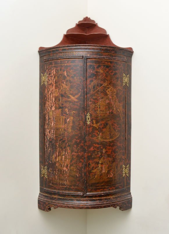 RED CHINOISERIE BOWFRONT HANGING CORNER CABINET: RED LACQUER CHINOISERIE BOWFRONT HANGING CORNER CABINET: 19th century, shaped top etagere shelves over molded cornice, 2 bowfront doors with chinoiserie motif paint decorated outdoor genre scenes. Bra