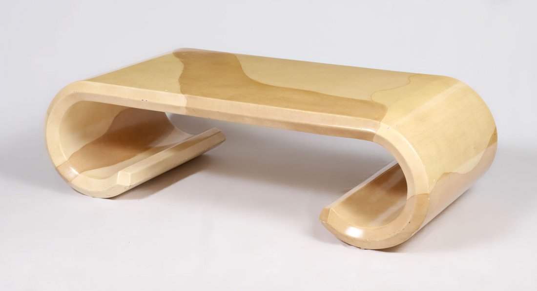 ATTRIB. KARL SPRINGER SCROLL COFFEE TABLE: ATTRIB. KARL SPRINGER SCROLL COFFEE TABLE: Unmarked, painted and lacquered body with scroll legs, overall measures 16 1/2" h. x 26 1/4" x 54 1/2".