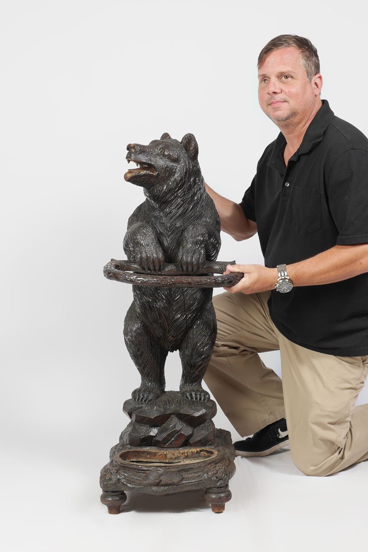 BLACK FOREST CARVED FIGURAL BEAR UMBRELLA STAND: BLACK FOREST LINDEN CARVED FIGURAL BEAR UMBRELLA STAND: Late 19th to early 20th century nicely detailed carved linden wood figure of a standing bear looking right, standing on rock, lower metal insert