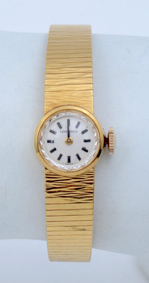 LONGINES 18K LADIES COCKTAIL WATCH:: LONGINES 18K LADIES COCKTAIL WATCH: Bracelet and round case in 18K yellow gold. Mechanical watch with manual winding. Cream face with black hour markers and hands. Weight 27.1 grams. Marked 18k gold o