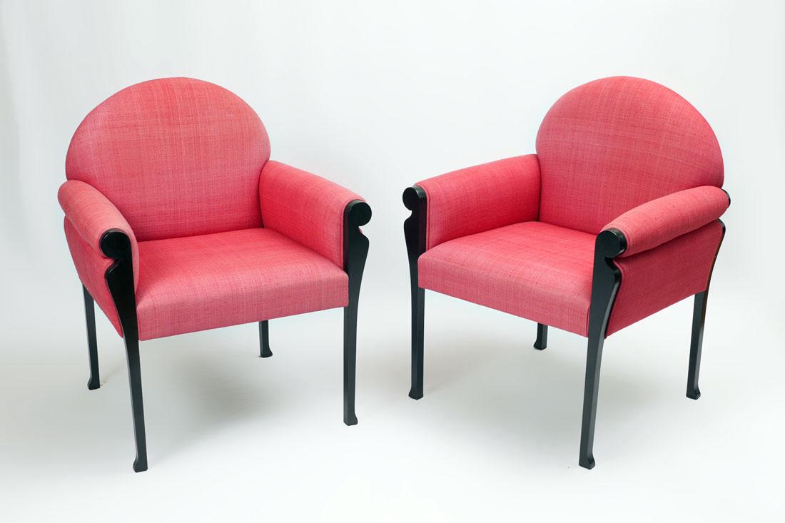 2 KARL SPRINGER STYLE ARM CHAIRS: 2 KARL SPRINGER STYLE ARM CHAIRS: Salmon colored upholstered chairs attributed to Karl Springer, ebonized wood legs and arm supports, 36" h. x 27" x 30".