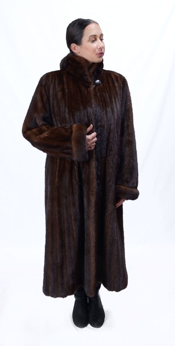 FULL LENGTH CHOCOLATE BROWN MINK COAT: FULL LENGTH CHOCOLATE BROWN MINK COAT: Revillon and Saks Fifth Ave labels are an indication of the quality of this fur coat with stand-up collar and cuffed sleeves. Large button at the neck secures th