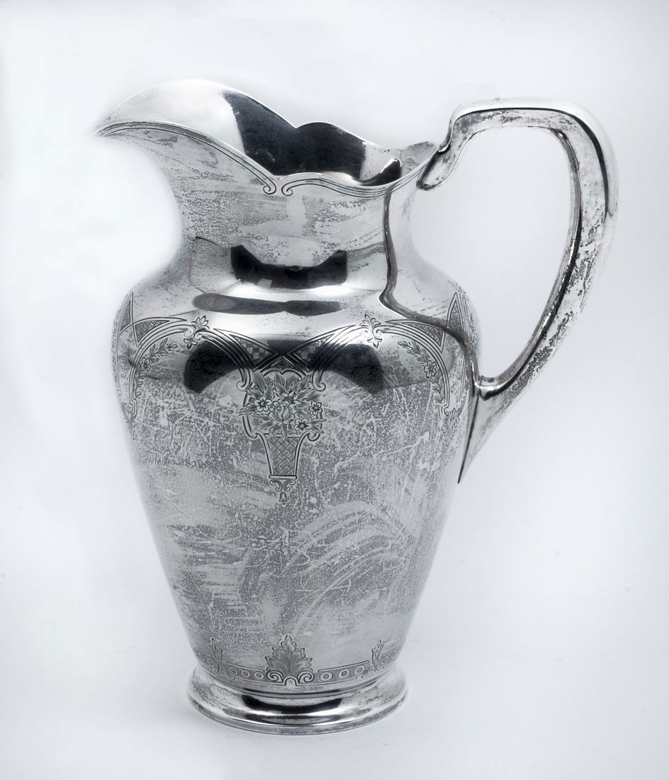 S. KIRK & SON ENGRAVED STERLING WATER PITCHER: S. KIRK & SON ENGRAVED STERLING WATER PITCHER: Scalloped rim, engraved floral basket and garland motif, marked S. Kirk & Son, 925/1000, 203A. Measures 9 1/4" h. x 7 1/2". Approx. 24.4 troy oz.