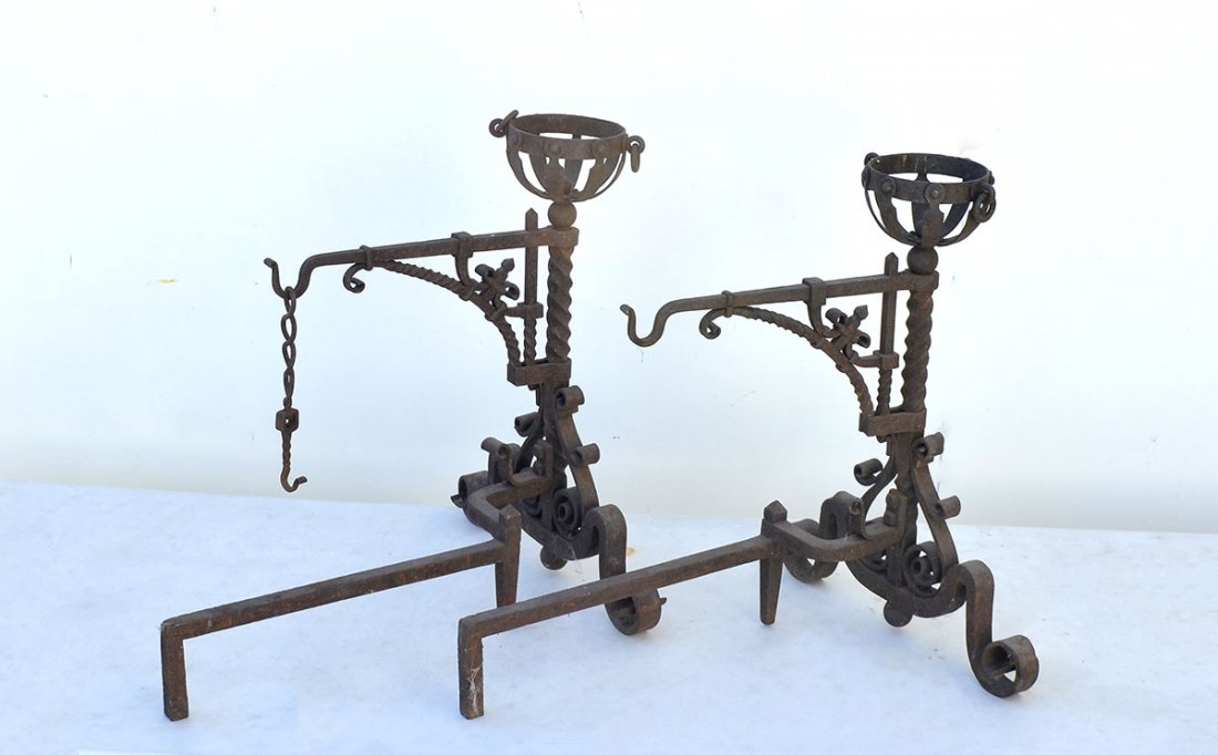 PAIR GOTHIC REVIVAL WROUGHT IRON ANDIRONS: PAIR GOTHIC REVIVAL WROUGHT IRON ANDIRONS: Basket form finials, twist shafts, scroll base and feet. Each with pot holder.