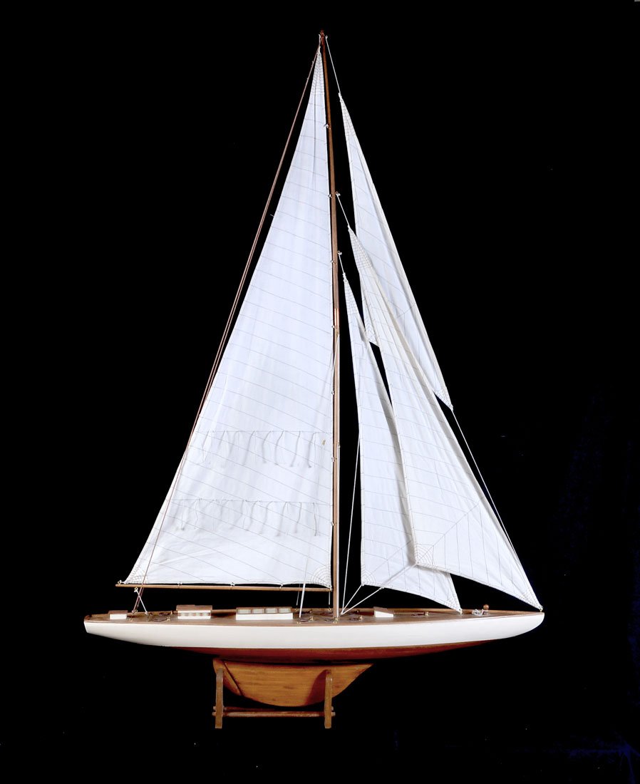 LARGE PAINTED WOOD MODEL SAIL POND BOAT: LARGE PAINTED WOOD MODEL SAIL POND BOAT: 20th century, top half of hull painted white, single mast, 3 cloth sails, approx. 71 1/2" h. x 50" x 9 1/4".