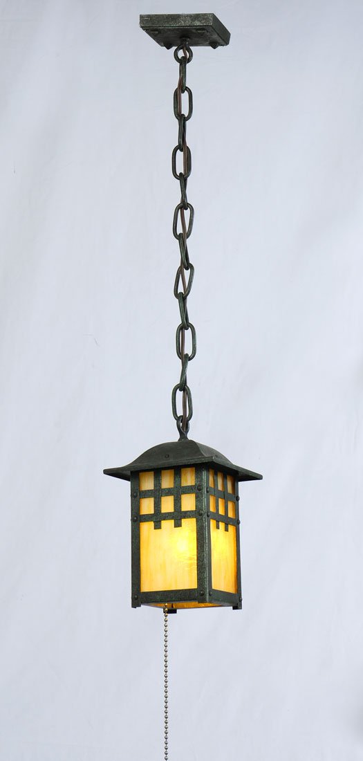 ARTS AND CRAFTS STYLE HANGING LIGHT: ARTS AND CRAFTS STYLE HANGING LIGHT: Verdigris patinated metal hanging light fixture, caramel slag glass panels, overall 9 1/2" h. x 6" x 6".