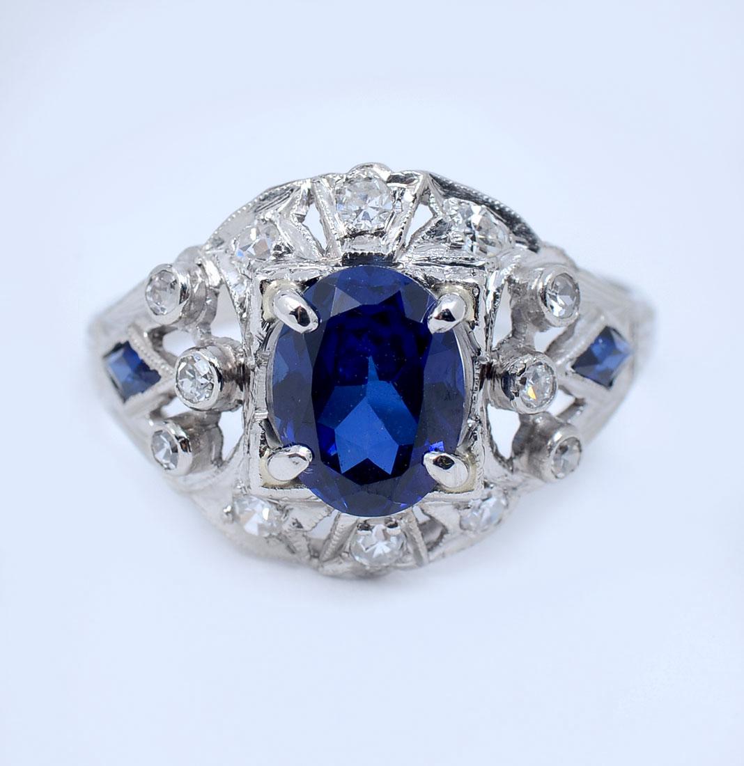 PLATINUM ART DECO DIAMOND & SYNTHETIC SAPPHIRE RI: PLATINUM ART DECO DIAMOND & SYNTHETIC SAPPHIRE RING: Period correct platinum ring contains one oval and 2 triangle synthetic sapphires. WEIGHT: 1.50 Ct. Approx. 12 round single cut diamonds. WEIGHT: .