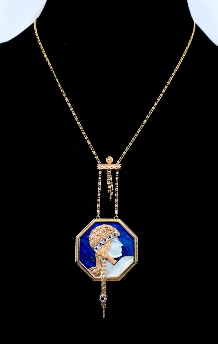 ERTE ''AVENTURE STATE'' LAPIS PENDANT NECKLACE: ERTE ''AVENTURE STATE'' LAPIS PENDANT NECKLACE: Erte ''Aventurine State'' pendant necklace; in 14k yellow gold, having mother of pearl, black onyx and diamond accents. Stamped: copyright CFA 14K 72/25