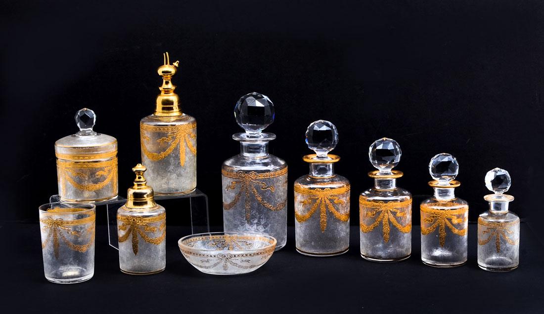 10 PIECE FRENCH ART GLASS VANITY SET: 10 PIECE FRENCH ART GLASS VANITY SET: 19th century, Baccarat quality etched patterned bodies and gold decorated garland swag designs. Comprises of a graduated bottle set, 2 perfumes, tray and covered 