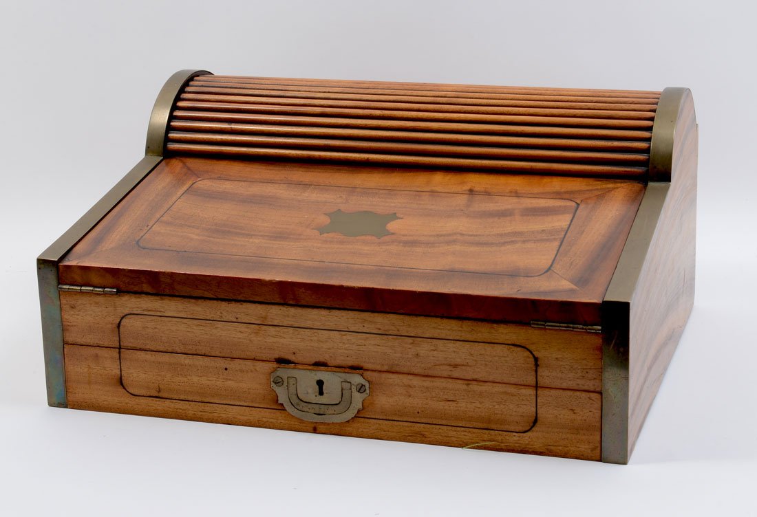 MAHOGANY MECHANICAL ROLL TOP LAP DESK: MAHOGANY MECHANICAL ROLL TOP LAP DESK: A unique mechanical roll top desk, opens when bottom drawer is pulled out to reveal a pop up fitted storage compartment. Hinged lid with embossed leather writing