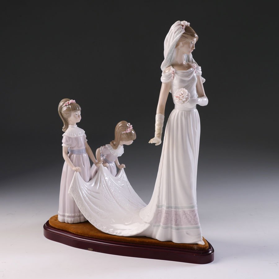 LLADRO HERE COMES THE BRIDE 1446 PORCELAIN FIGURINE: LLADRO HERE COMES THE BRIDE 1446 PORCELAIN FIGURINE: Spanish name "Camino del Altar", sculptor Jose Puche, issued 1983, retired 1997, glazed finish, 13 1/2" h.