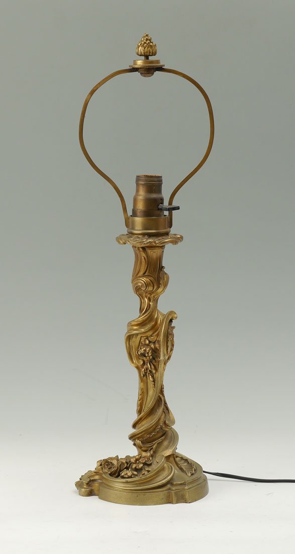 GAGNEAU FRENCH GILT BRONZE LAMP: GAGNEAU FRENCH GILT BRONZE LAMP: Early 20th century, rococo style foliate scroll design, heavy case gilt bronze, single socket fixture, signed on base Gagneau Paris. Overall 22" h. x 6 1/2".
