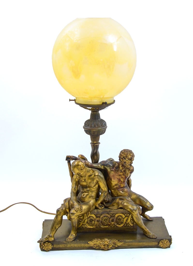 SEMI NUDE FIGURAL CAST BRONZE LAMP: SEMI NUDE FIGURAL CAST BRONZE LAMP: Heavy cast bronze, neo-classical style with 2 seated figural semi nude men on base with masqueron and rosettes, single socket fixture, 15 1/4" h. x 14 1/4" x 6 1/2"