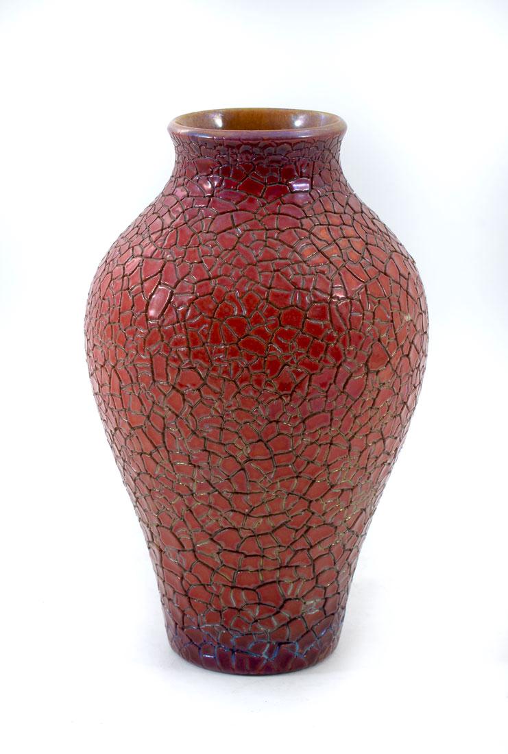 ZSLONAY CRACKLE GLAZE ART POTTERY VASE: ZSLONAY CRACKLE GLAZE ART POTTERY VASE: Baluster form vase, deep red crackle glaze, Zsolnay Pecs Church mark, 7 3/4'' h. x 4 3/4''