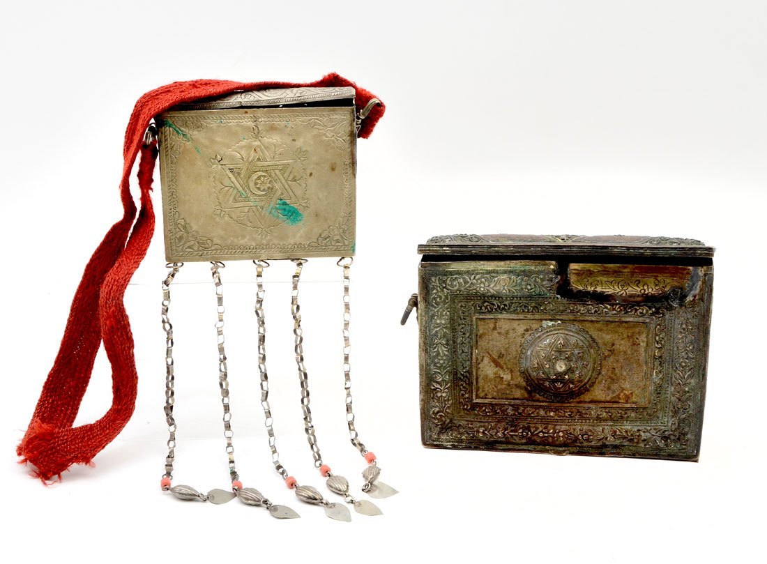 2 EMBOSSED METAL KORAN CASES / BOXES: 2 EMBOSSED METAL KORAN CASES / BOXES: Designed to hold a copy of the Islamic Koran or Quran, to include 1) Embossed and engraved brass body with hinged lid, 5 1/4" x 7" x 1 1/4". 2) Silver toned metal