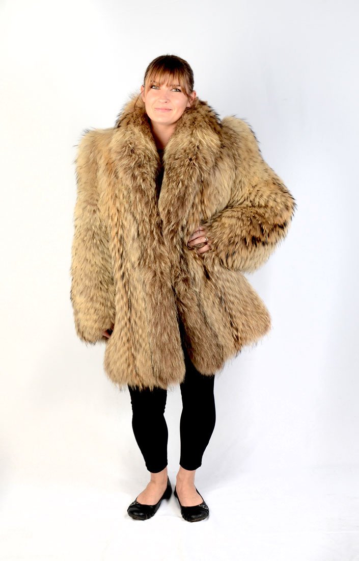 RACCOON STROLLER JACKET: RACCOON STROLLER JACKET: Beautiful natural raccoon fur coat in the versatile stroller length. It has a large shawl collar and lightly padded shoulders as well as gorgeous markings. There are two exter