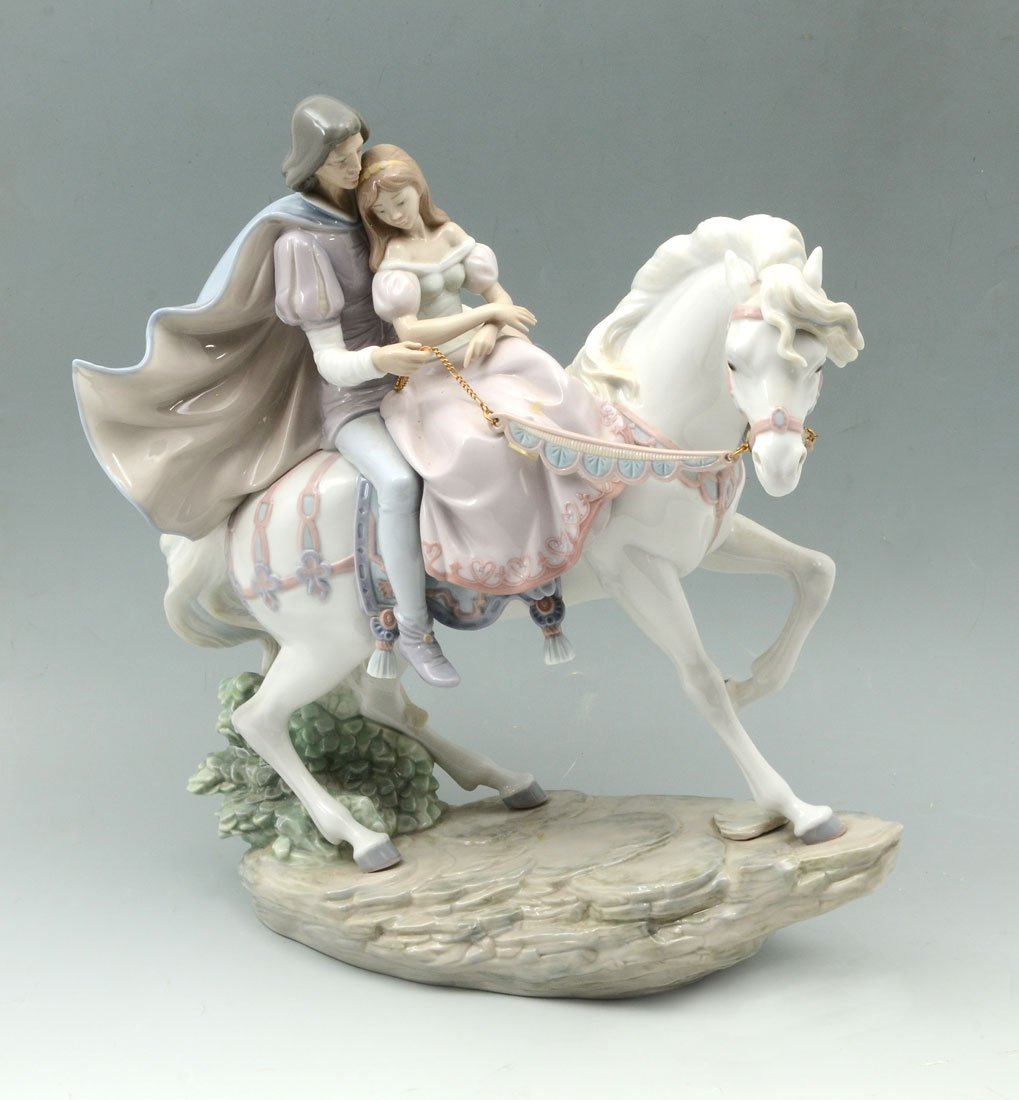 LARGE LLADRO LOVE STORY 5991 PORCELAIN FIGURINE: LARGE LLADRO LOVE STORY 5991 PORCELAIN FIGURINE: Spanish name "Blanca Nieves y El Principe", sculptor Jose Puche, retired 2001, 14 1/4" h. x 13 1/2" long. Sold with original box 17" h. x 20 1/2" x 13"