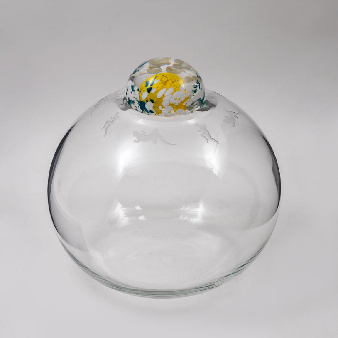 DUNCAN MCCLELLAN ART GLASS GLOBE AND STOPPER: DUNCAN MCCLELLAN ART GLASS GLOBE AND STOPPER: Clear glass globe with engraved alternating lizard and figural running man designs, signed on base, dated '92, and numbered 4/25, measures 8 1/2'' h. x 10