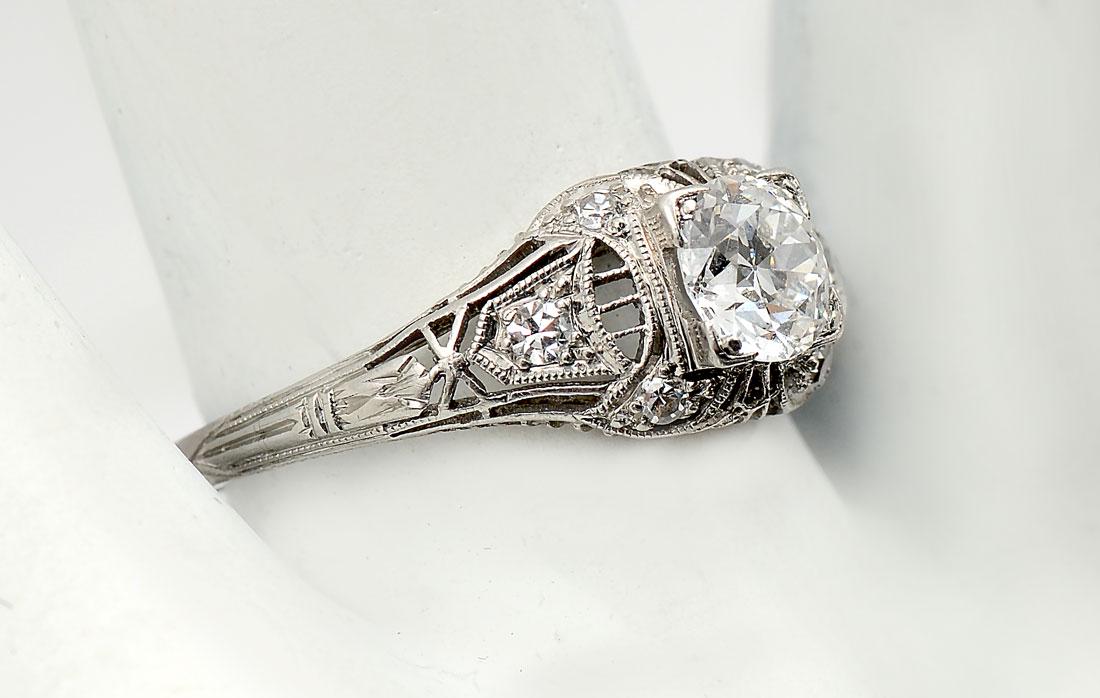 PUFFY PLATINUM EDWARDIAN DIAMOND RING: PUFFY PLATINUM EDWARDIAN DIAMOND RING: Platinum "Puffy" ring has well done filigree work with 1 old European diamond in the center approx .65 CT, rated VS1 in clarity and G in color. 6 single round cu