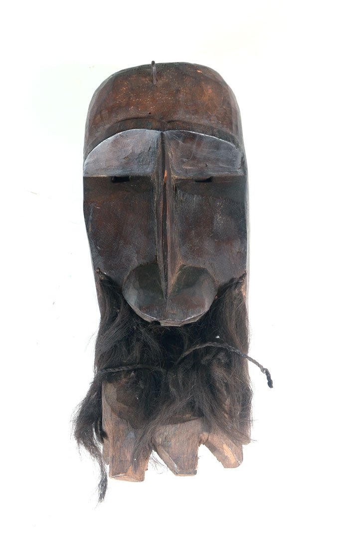 WEST AFRICAN DAN CARVED GAGON FACE MASK: WEST AFRICAN DAN CARVED GAGON FACE MASK: Carved wood squared face with elongated nose over hair over beak with carved ''teeth'', Dan culture, Ivory Coast/Cote d'Ivoire, 15'' h. x 5 3/4'' x 5''.