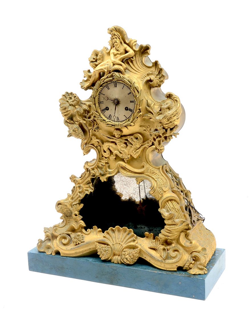 CAST BRASS POSEIDON MANTLE CLOCK: CAST BRASS POSEIDON MANTLE CLOCK: Turn of the century with Poseidon atop and a sea Nymph is battling a sea creature. The Gold tone finish is very complimenting to the seashell and cresting wave design