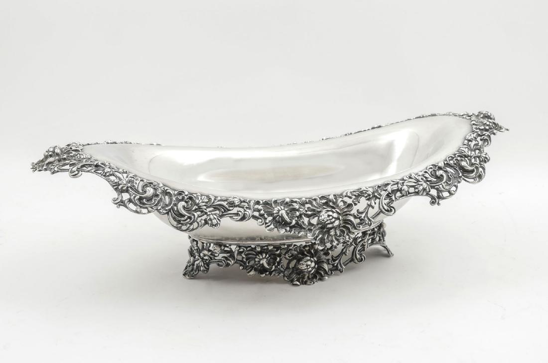 MAUSER STERLING SILVER PIERCED SERVING BOWL: MAUSER STERLING SILVER PIERCED SERVING BOWL: Sterling silver elongated serving bowl with scrolling foliate and flowers encompassing rim and footing. Made by the Mauser manufacturing Co. (1887-1903) of