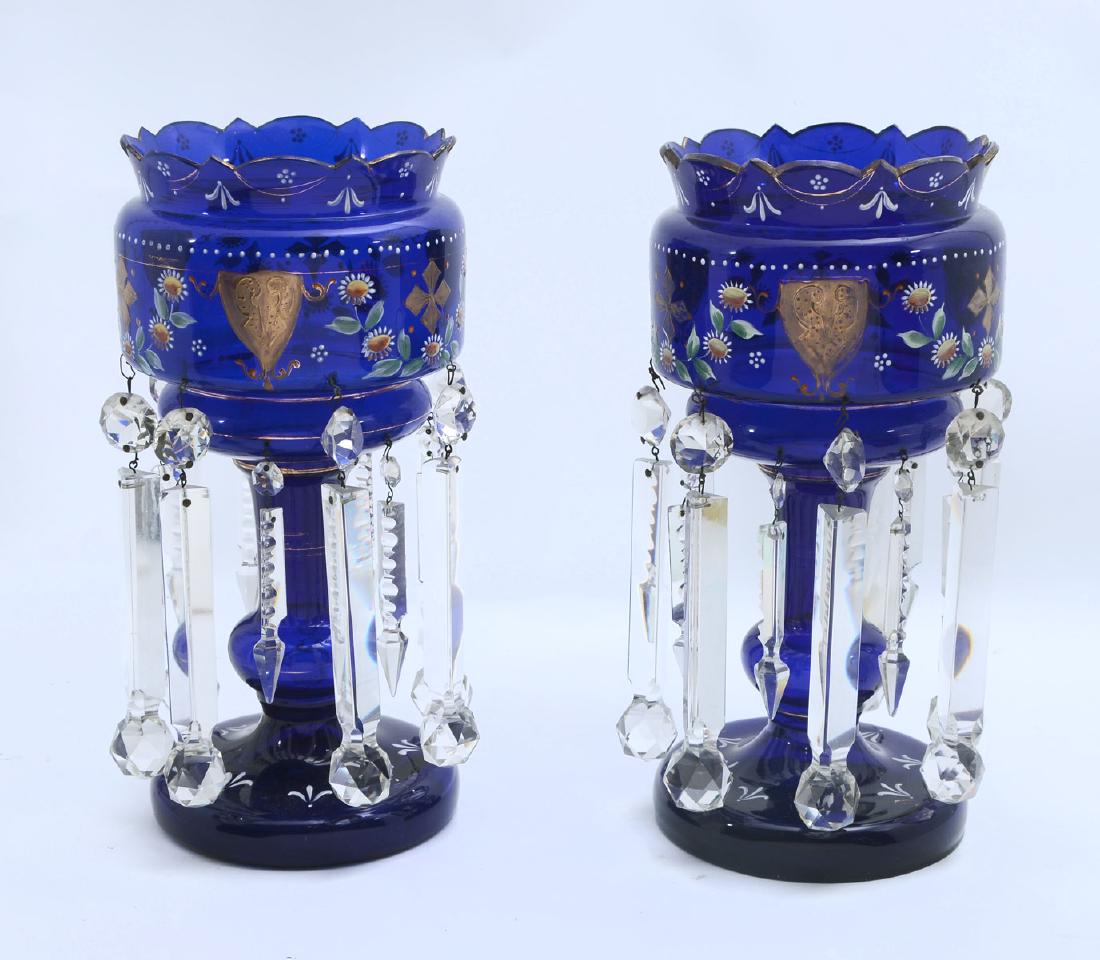 PAIR OF COBALT BLUE MANTLE LUSTERS: PAIR OF COBALT BLUE MANTLE LUSTERS: Pair of Bohemian Cobalt blue mantle lusters that are decorated with an empaneled floral and foliate design with gold accenting. Both are encompassed by 2 tiers of m