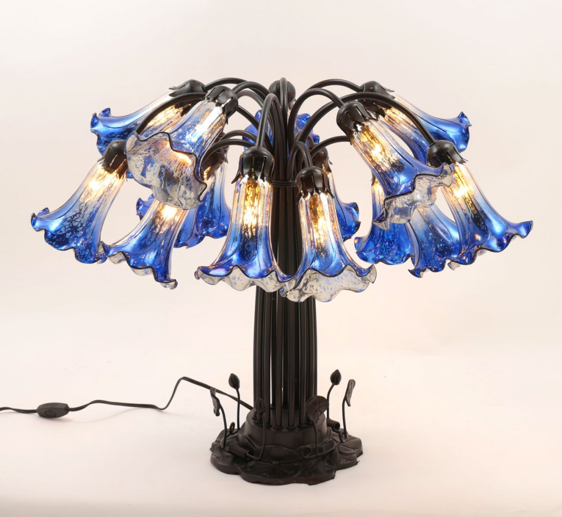 15-LIGHT TIFFANY STYLE TULIP LAMP: 15-LIGHT TIFFANY STYLE TULIP LAMP: This Tiffany style 15-light lamp has spotted blue & mercury glass tulip shaped shades. Attached by arched arms to metal base with lotus leaf form design. Approx. 22"