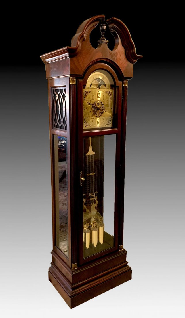 HOWARD MILLER GRANDFATHER CLOCK: HOWARD MILLER GRANDFATHER CLOCK: Howard Miller grandfather clock with gridiron pendulum and openwork face. Beveled glass to front & sides. Registered serial number 551838. Approx. 87.75" h x 25.75" l 