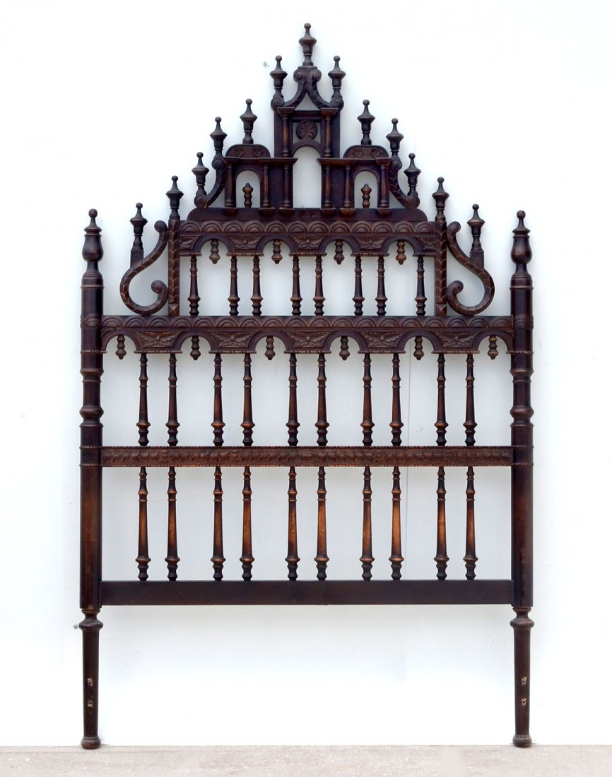 VICTORIAN GOTHIC STYLE HEADBOARD: VICTORIAN GOTHIC STYLE HEADBOARD: Gothic style Victorian headboard with 15 turned finials reside atop. Removable crest is carved with fluted columns and arches. Carved foliate and arch design. Approx.