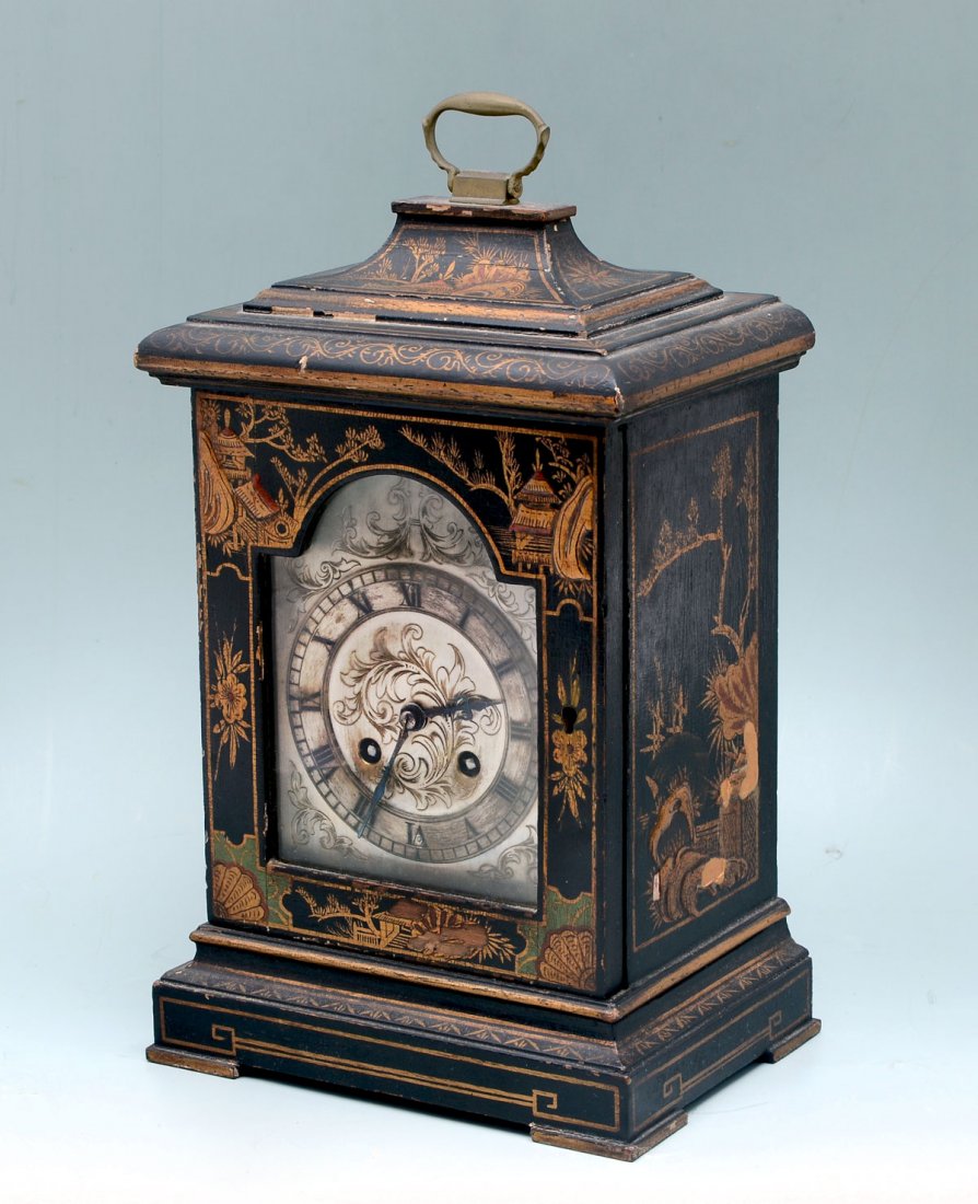 19th CENTURY FRENCH CHINOISERIE MANTLE CLOCK: 19th CENTURY FRENCH CHINOISERIE MANTLE CLOCK: Mid 1800's French black lacquered chinoiserie themed mantle clock with brass handle atop. Gold painted Chinese style scenes with an intricately incised si