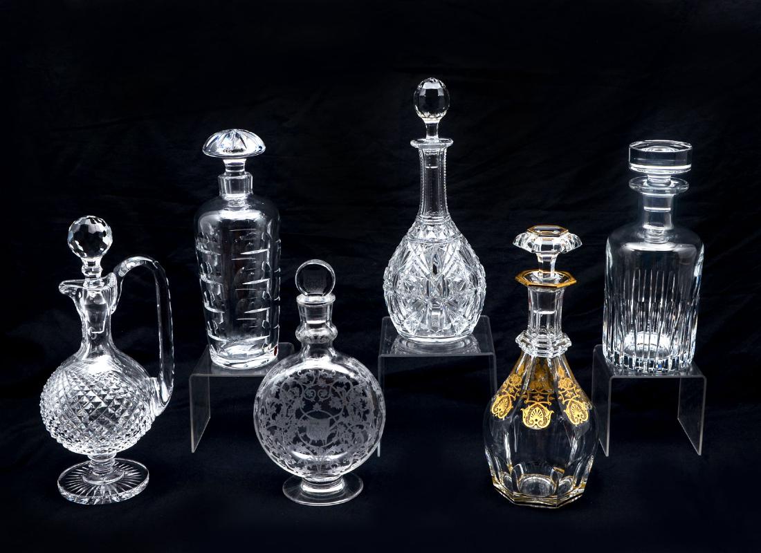 6 PC. BACCARAT & ORREFORS CRYSTAL DECANTERS: 6 PC. BACCARAT & ORREFORS CRYSTAL DECANTERS: Comprising 1 vertically ribbed Baccarat decanter, 1 etched scrolling foliate designed Baccarat decanter with a 3 hammer & bird coat of arms, 1 Baccarat dec