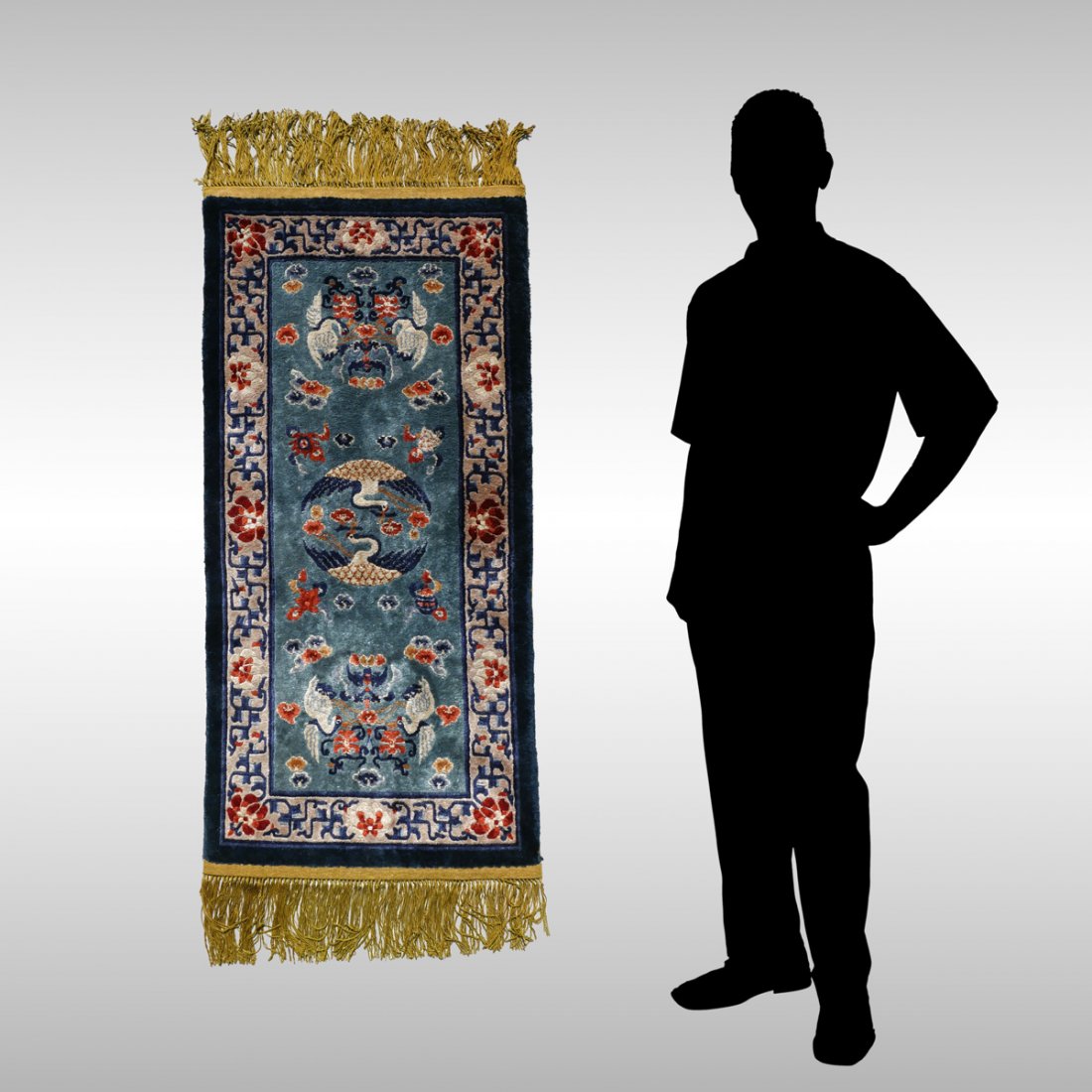 CHINESE HK SILK RUG, 2' X 4': CHINESE HAND KNOTTED SILK RUG, 2' X 4': The main theme is of cranes (symbolizing marital harmony) in white and black on a medium blue field.