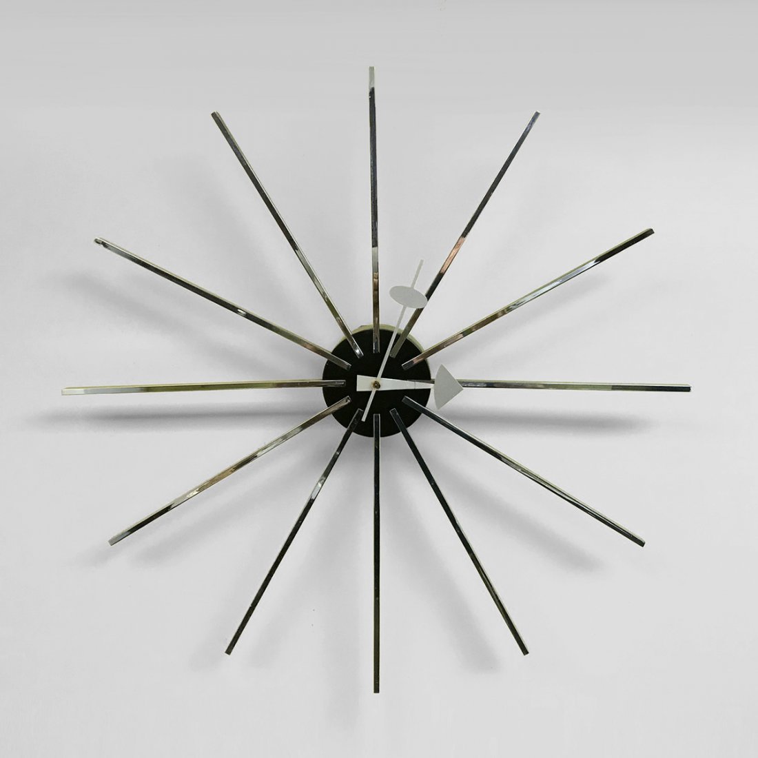 GEORGE NELSON FOR HOWARD MILLER MID-CENTURY CLOCK: GEORGE NELSON FOR HOWARD MILLER MID-CENTURY CLOCK: Mid-century stainless-steel wall clock designed by George Nelson for Howard Miller. Plug is built into verso of clock. Also included is the wall moun