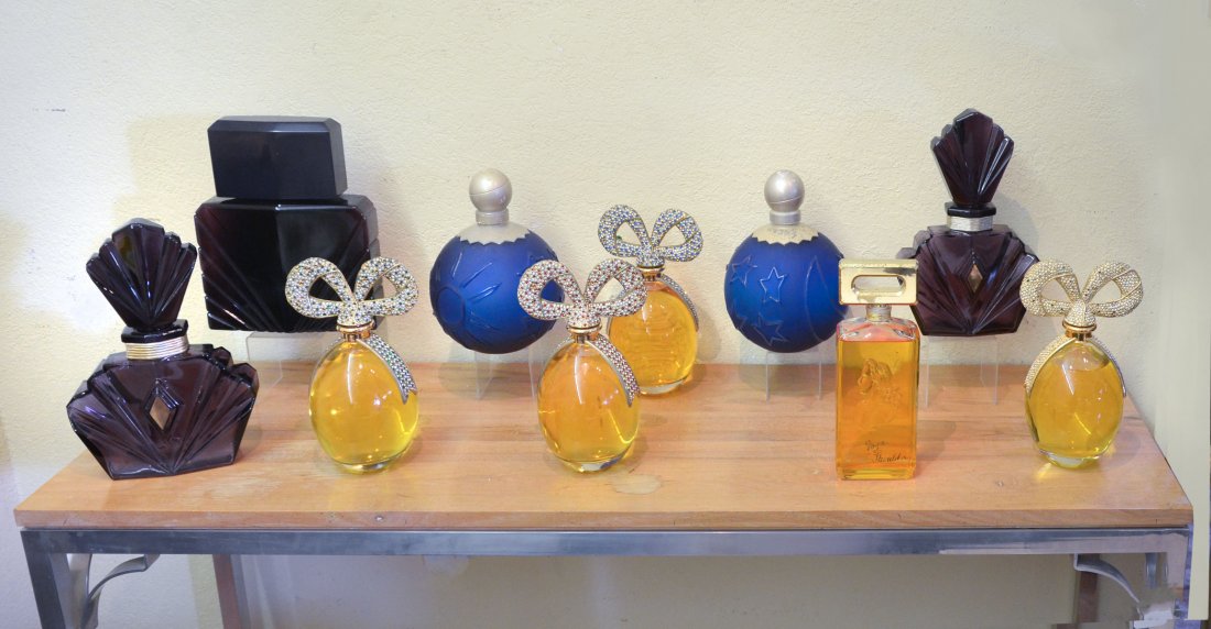 10 STORE DISPLAY PERFUME BOTTLES: 10 STORE DISPLAY PERFUME BOTTLES: Comprising 3 purple art deco bottles, 2 satin blue round bottles with raised sun, moon, and stars, 1 White shoulder perfume display bottle, & 4 egg-shaped bottles wit