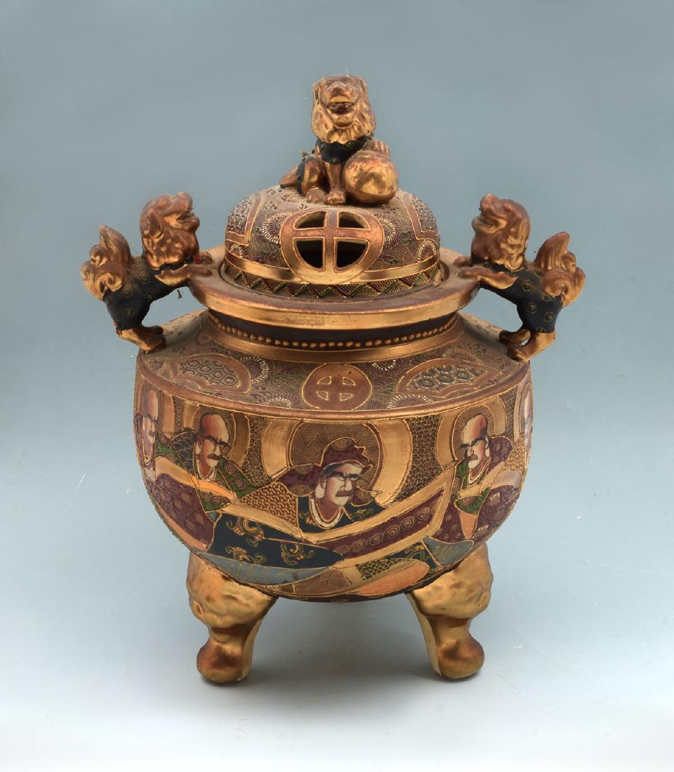 LARGE SATSUMA MORIAGE LIDDED CENSER: LARGE SATSUMA MORIAGE LIDDED CENSER: Early 1900's Satsuma censer decorated with Arhats in Moriage and heavy gilt. 2 foo dogs at top rim with one foo dog & ball finial. Signed on underside in red and b