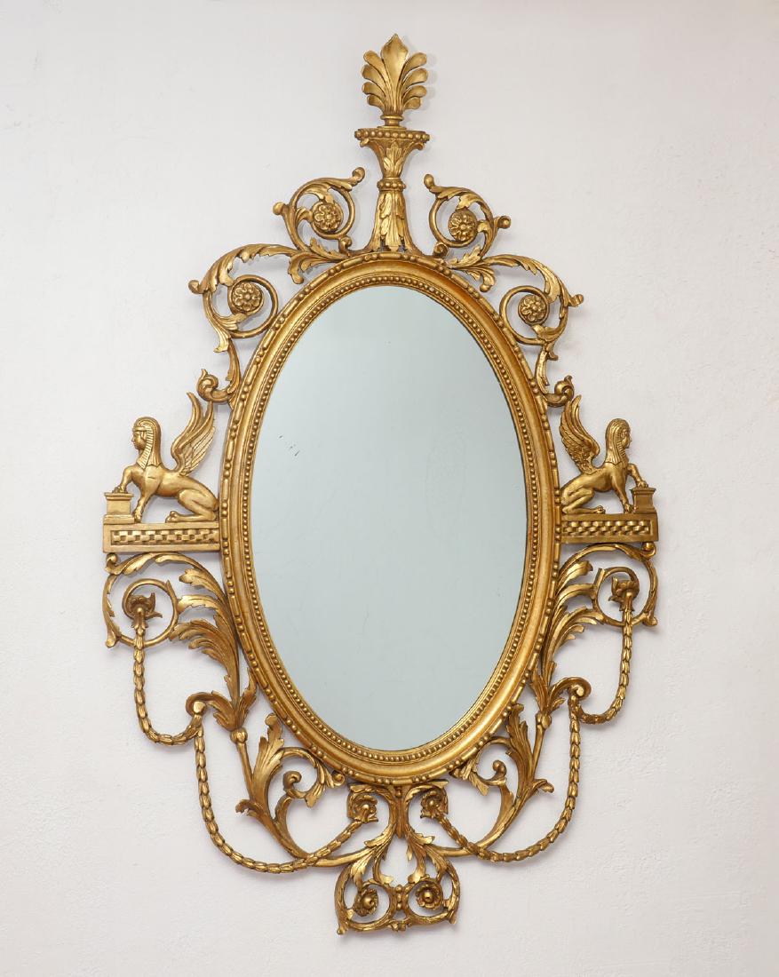 GILT CHIPPENDALE SPHINX MIRROR: GILT CHIPPENDALE SPHINX MIRROR: Mid 19th century, American: Originally from Livingston Farm near Leesburg, Virginia. Hand carved wood with gilt & gold leaf frame with oval mirror in center of a pierce