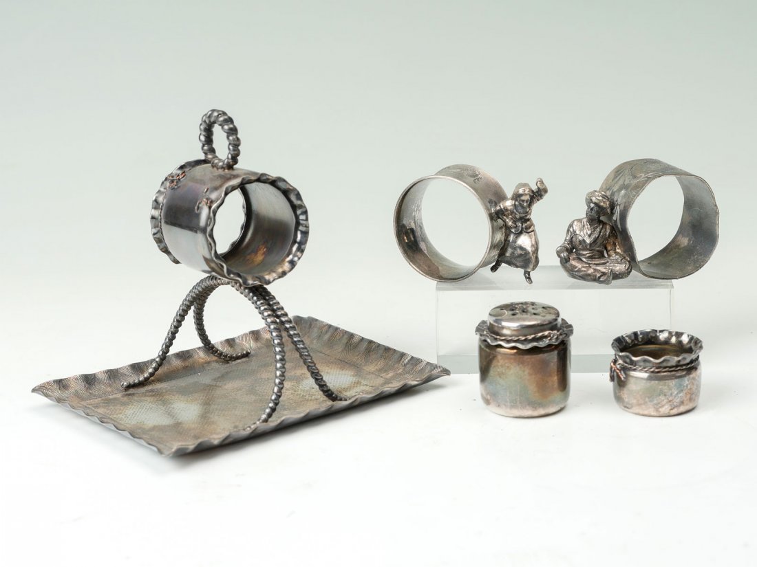 5 PC. FIGURAL NAPKIN RINGS: 5 PC. FIGURAL NAPKIN RINGS: Comprising 1- holder raised over a tray with a rope design, by S.F Meyers& Co., 1-Salt & 1- Pepper shaker, both by Pairpoint Mfg. Co. , 1- Dancing woman holder, and 1- sitt