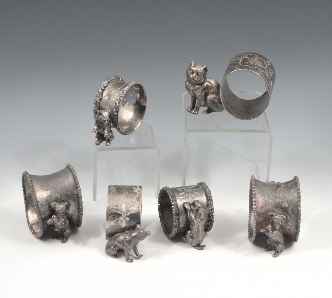 6 PC. FIGURAL NAPKIN RINGS: 6 PC. FIGURAL NAPKIN RINGS: Comprising 4 - Dog napkin holders with etched work and no makers marks, 1- Cat holder with etched ring , and 1- Large cat napkin holder by Nickerbocker. Largest Approx. 2.2