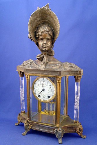 SETH THOMAS EMPIRE NO. 31 CRYSTAL REGULATOR CLOCK: SETH THOMAS EMPIRE NO. 31 CRYSTAL REGULATOR CLOCK: Circa 1909. Cast metal figural top with lady in a bonnet. 6 Footed base. 2 unique cut glass columns. 4 sided beveled glass case, glass is perfect. Po