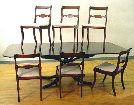 CHAREK MAHOGANY DINING TABLE W/ 6 CHAIRS 1930'S: CHAREK DUNCAN PHYFE STYLE MAHOGANY DINING TABLE WITH SIX CHAIRS CA. 1930'S: Single pedestal with splayed legs, drop leaf dining table with three extra 14 1/2" leaves. Table is 51"long with drop leaves