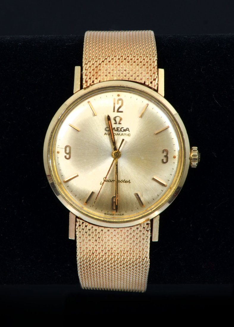 VINTAGE GENTS 14K SEAMASTER WATCH: VINTAGE GENTS 14K SEAMASTER WATCH: Vintage Omega Seamaster 14 Karat Gold Watch and bracelet. Dial with baton hour markers and Arabic numerals at 3, 6, 9 & 12, and automatic movement. Signed on dial Om